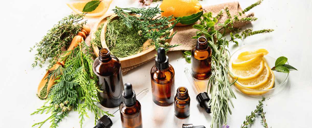 herbs on the table and essential oil bottles