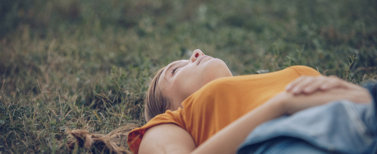 teenager relaxing and lying on grass