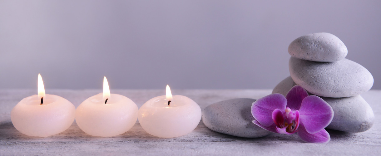 candles rocks and orchid