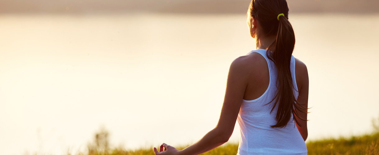 a woman mediating in nature